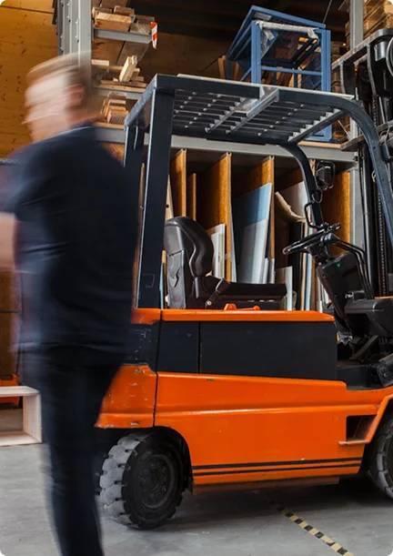 blurry guy walking past a forklift